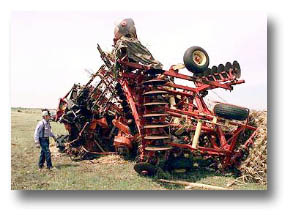 A farmer surveys the damage done to his tractor in the aftermath.